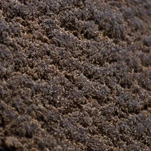 Macro dell'Afghan Hash 60% THCX, grana secca con riflessi ambrati